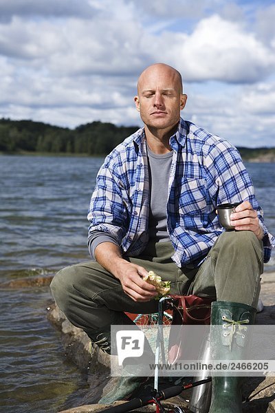 Portrait of a smiling man by the water Sweden.