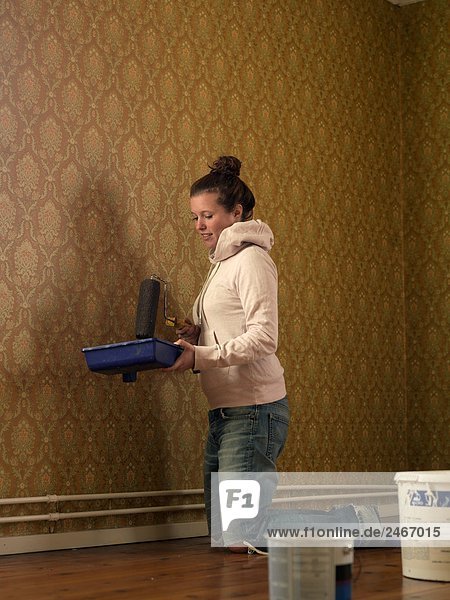 A young woman renovating a room Sweden.