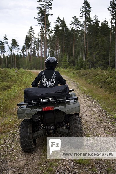 Four-wheeler on a forest road Sweden.