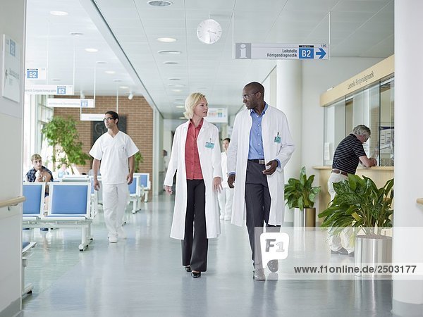 Doctors walking in corridor of hospital