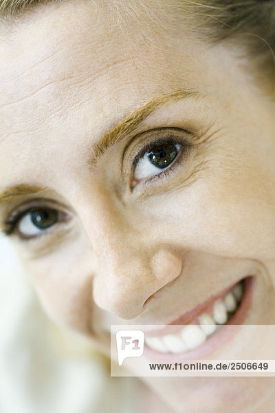 Woman smiling at camera  extreme close-up  portrait