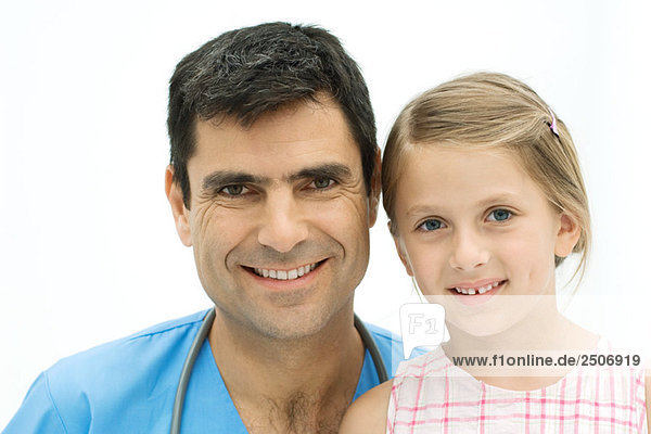Male nurse together with girl  both smiling at camera  portrait