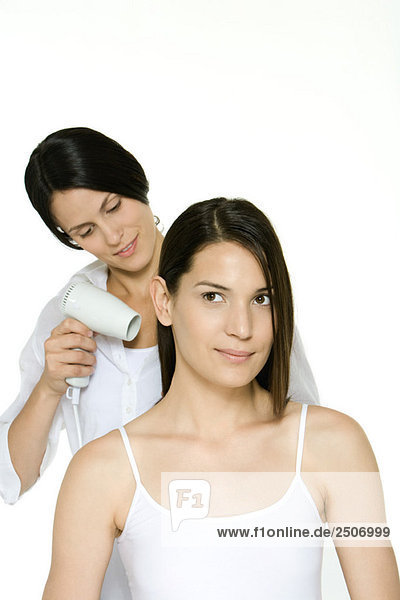 Friseurin föhnen das Haar einer Frau