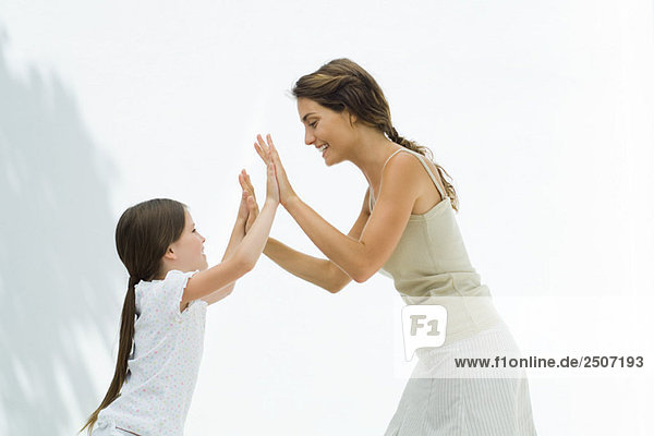 Mother and daughter playing clapping game together