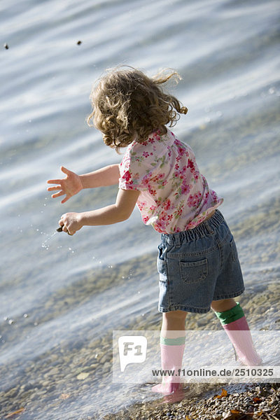 little girl (3-4) playing on beach