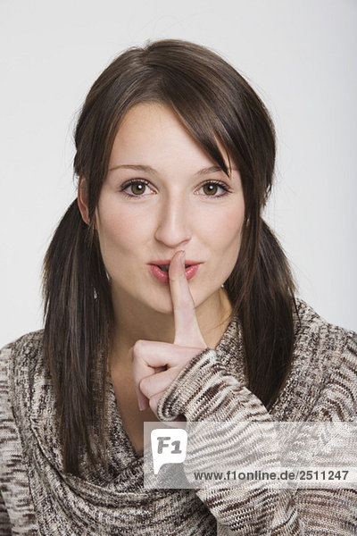 Young woman  finger to mouth  portrait