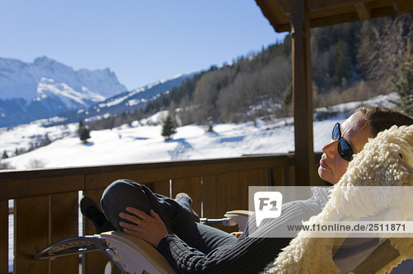 Switzerland  Graubuenden  Savognin  woman relaxing on sun terrace