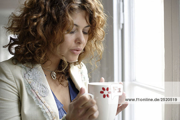 Woman holding cup of warm drink