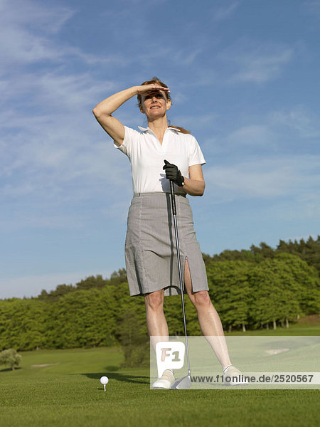 Woman at golf tee