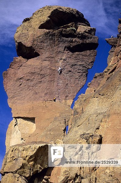 'Climbers on the ''Monkey Face''  Smith Rock State Park  near Terrebonne  Oregon'