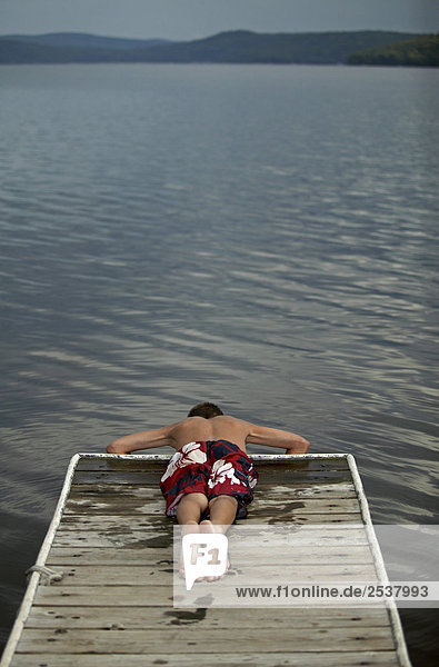 Boy Laying at End of Dock