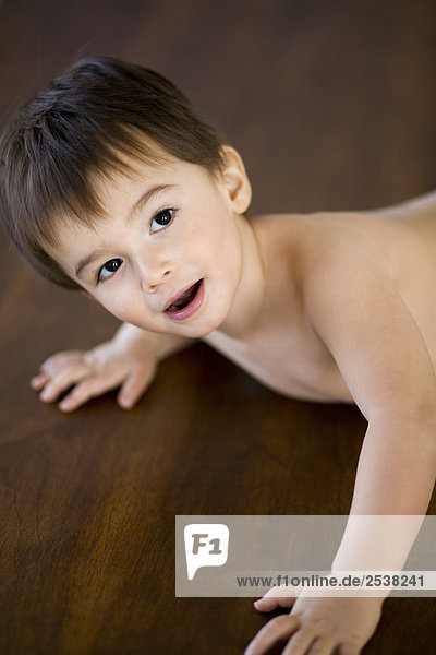 Boy Crawling on Hardwood Floor