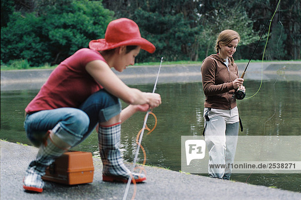 Two Young Women Preparing to Fish