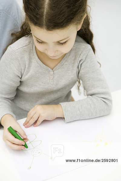 Little girl drawing with crayon