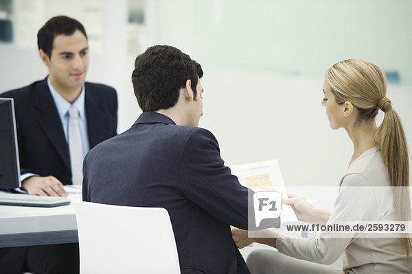 Professional meeting with clients  couple analyzing document together