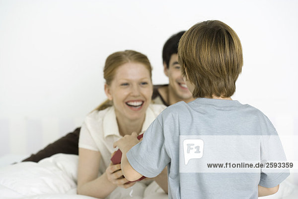 Boy giving mother gift  rear view