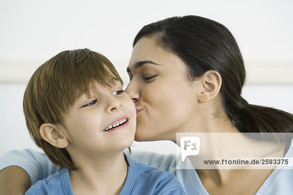 Mother kissing son on the cheek