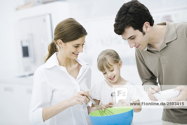 Family cooking together in kitchen
