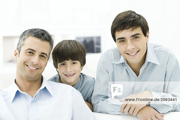 Father and sons smiling at camera  portrait