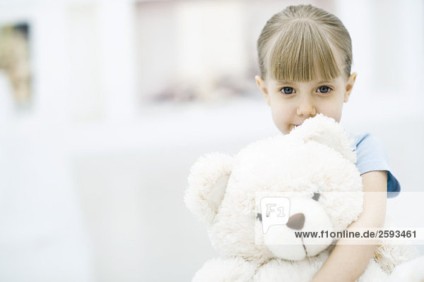 Little girl holding teddy bear  portrait