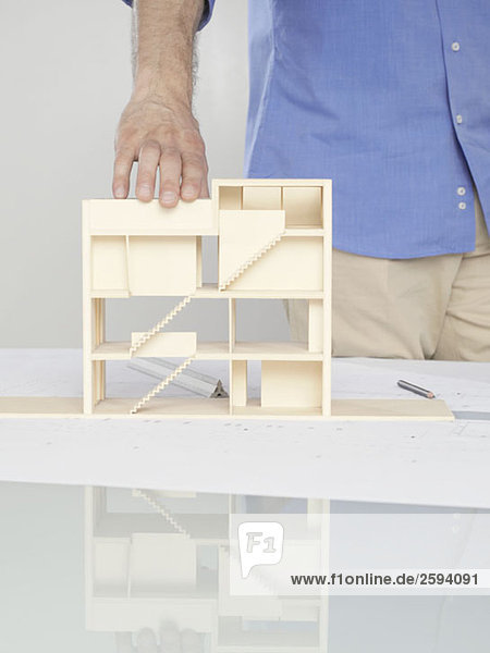 A man looking at an architectural model