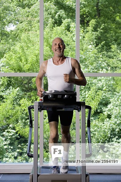A mature man running on a treadmill