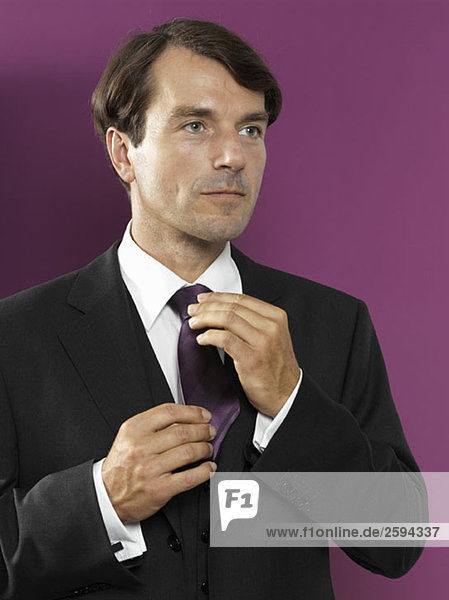 A man adjusting his tie