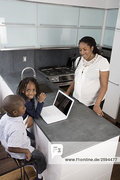Eine Mutter und ihre beiden Söhne in einer häuslichen Küche