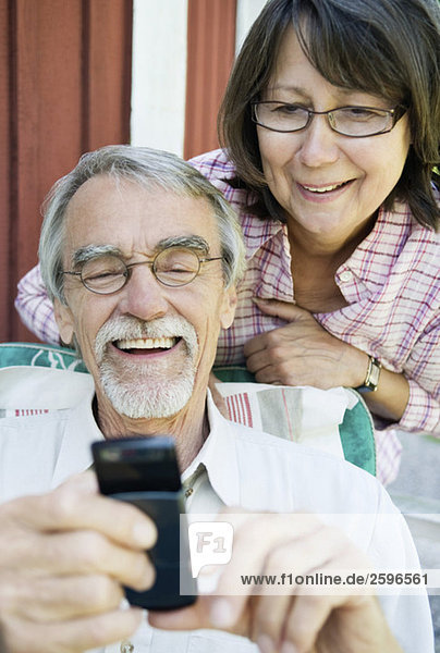 Man and woman reading on cell phone