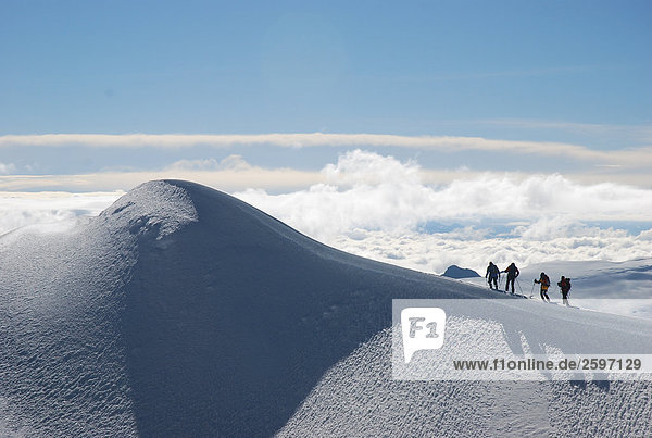 Hikers hiking on snow covered mountain