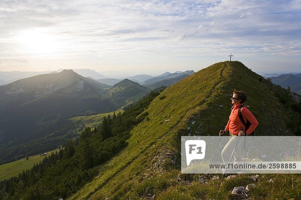 Female hiker standing on mountain Osterhorngruppe Schmittenstein Salzach valley Austria