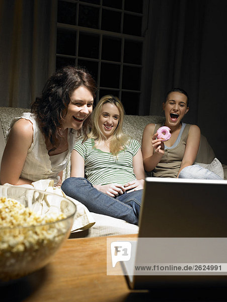Drei junge Frauen  die sich einen Film ansehen
