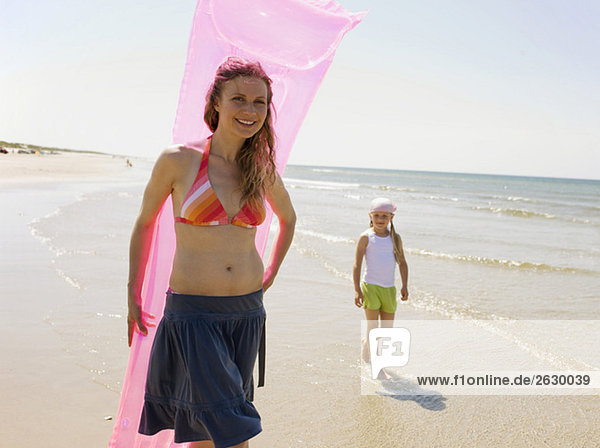 Germany  Baltic sea  Mother and daughter (6-7) walking on beach