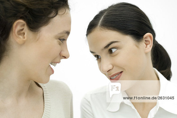 Two young women face to face  smiling  close-up