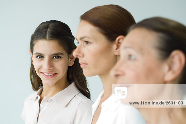 Three generations of women  focus on teen girl smiling at camera