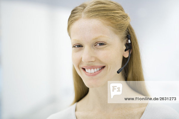 Professional woman wearing headset  smiling  portrait