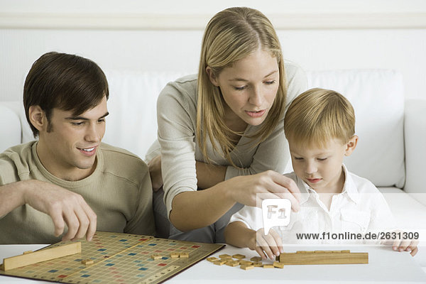 Family playing board game together