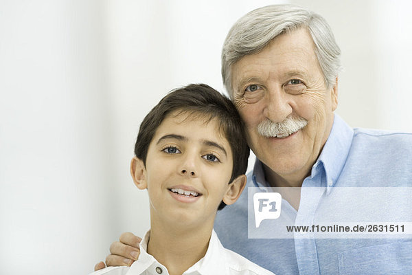 Grandfather and grandson smiling at camera  portrait