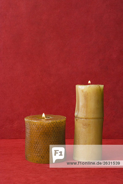 Two pillar candles  side by side  burning