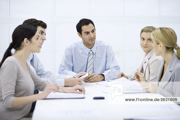 Businessman sitting with colleagues at conference table