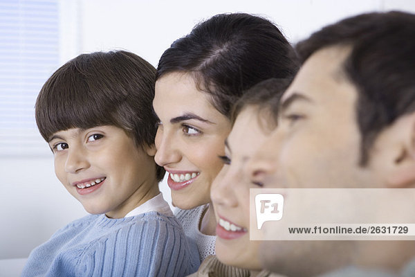 Young boy spending time with his family  smiling at camera