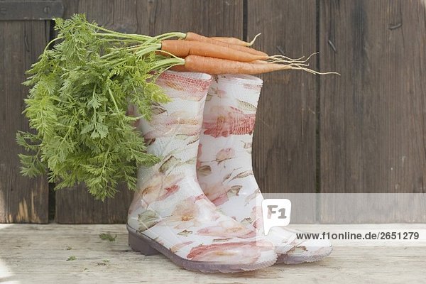 Carrots on top of rubber boots