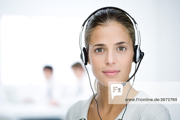 Woman wearing headset  looking at camera  portrait