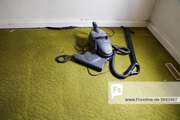 Vacuum Cleaner on Old Carpet