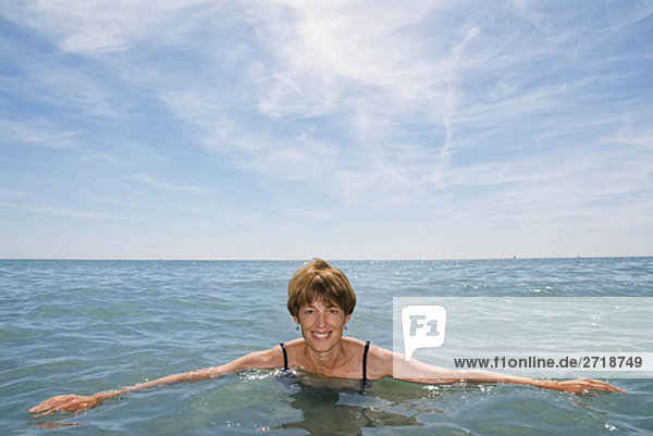 A woman in the sea smiling