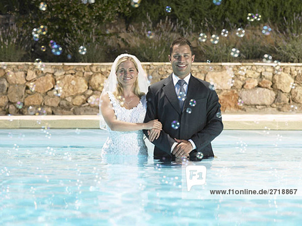 Bride and groom in pool