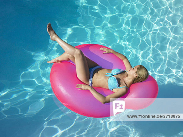 Woman on inflatable chair in pool