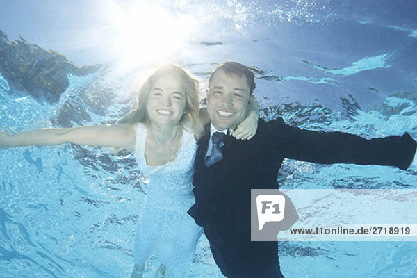 Bride and groom underwater