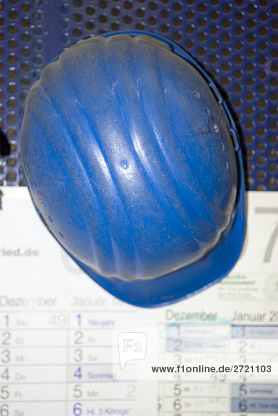 Hardhat lying on calendar  elevated view