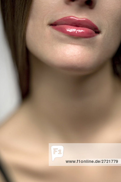 Woman wearing glossy lipstick  close-up mouth